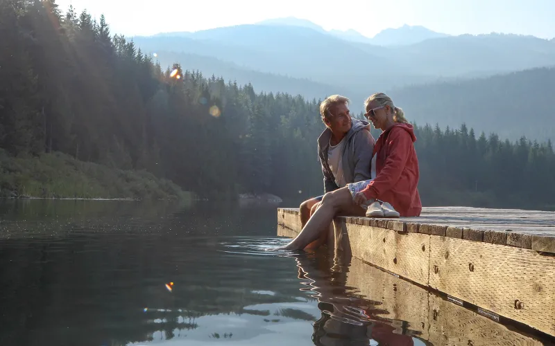 Retired couple sitting on a dock