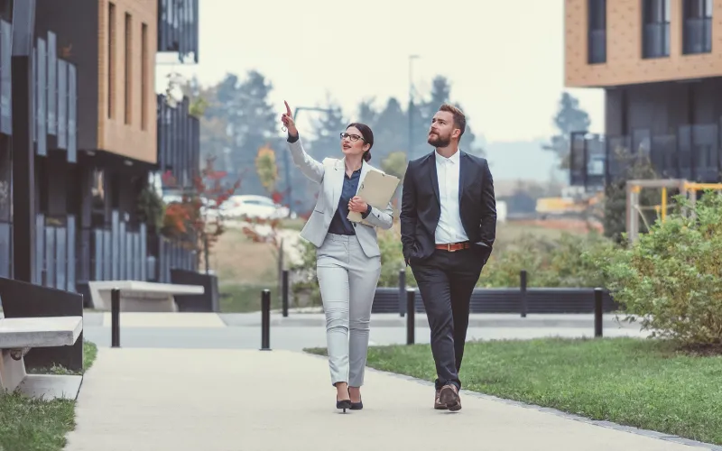 Couple walking in front of townhomes