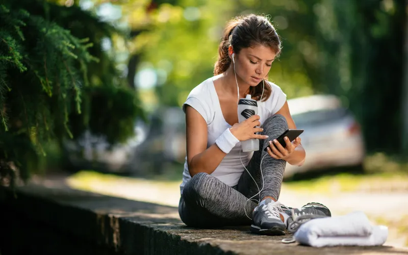 Woman on smartphone sitting on bench