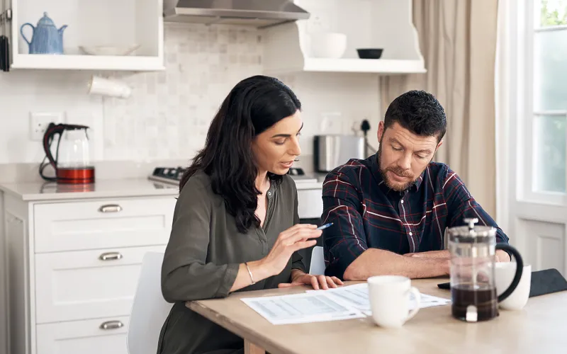 Couple planning at kitchen table