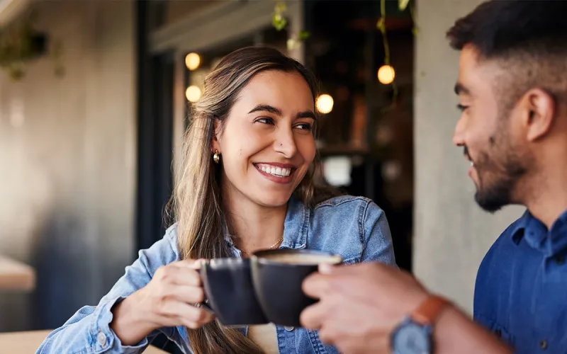 A man and woman having a coffee together in a cafe. 