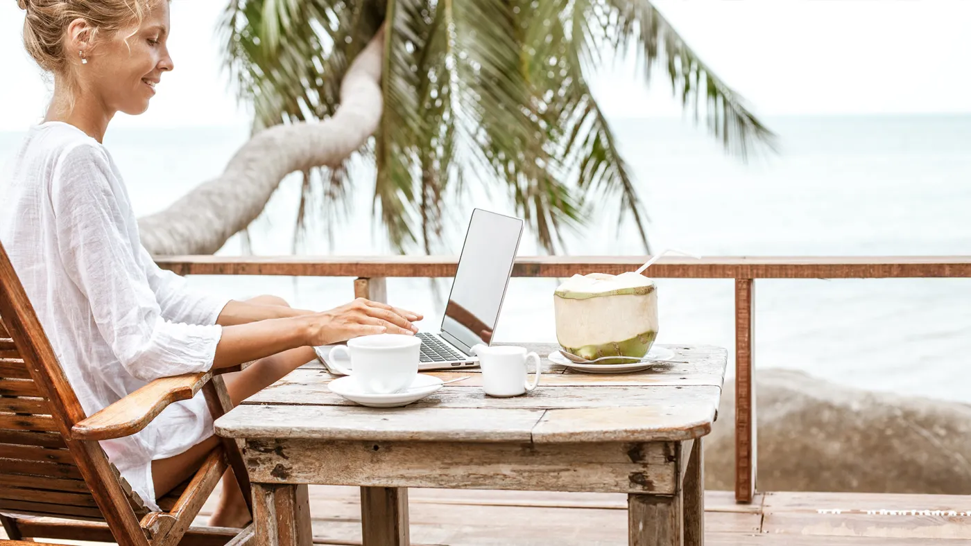 Woman working on a computer on her deck