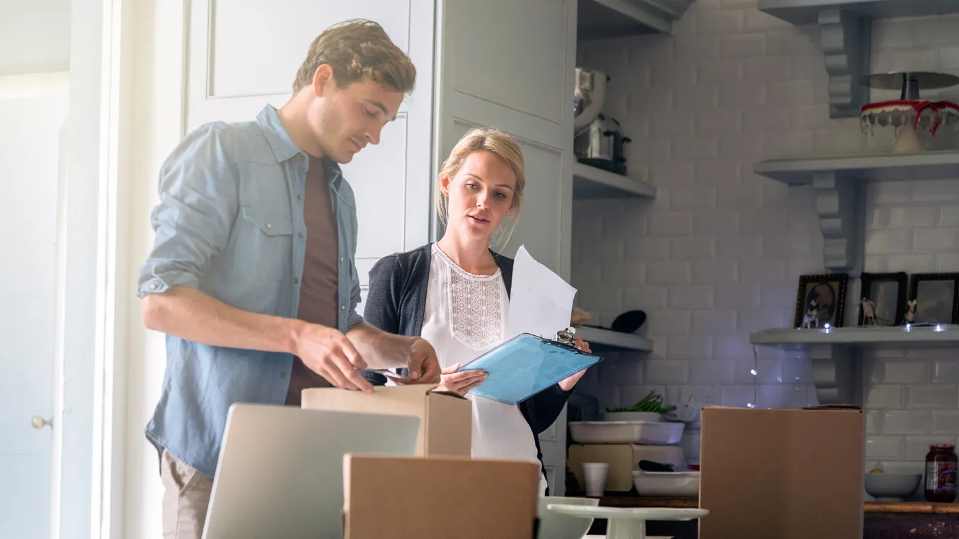 Two people looking at paper documents