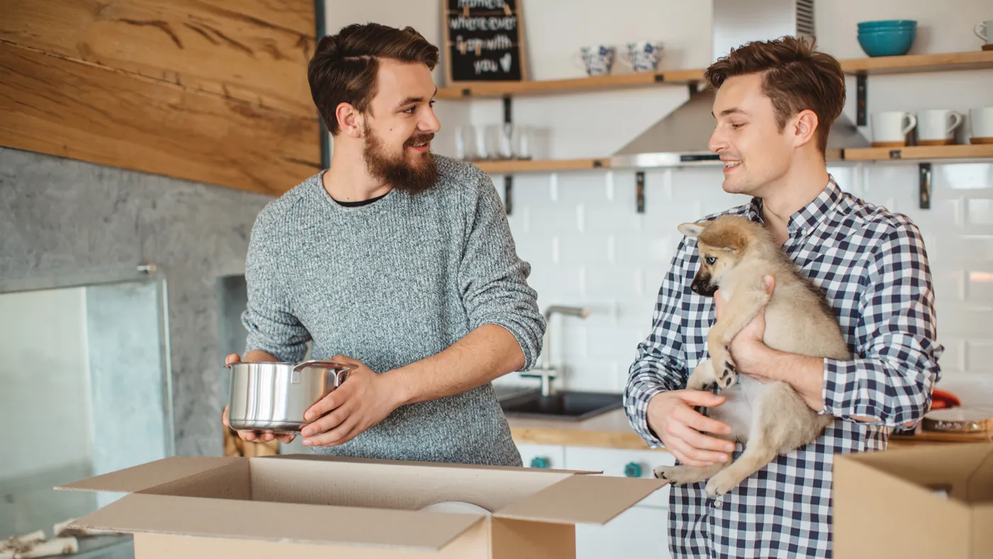 Two men unpacking boxes