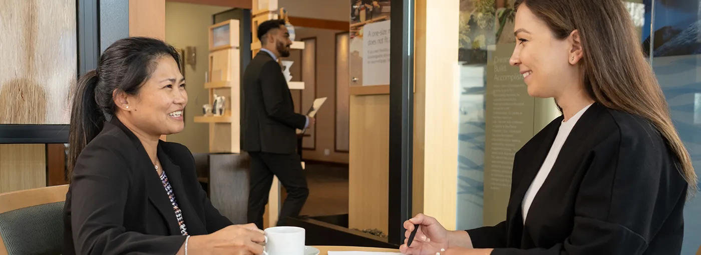 Clients speaking with a financial advisor at a BlueShore branch