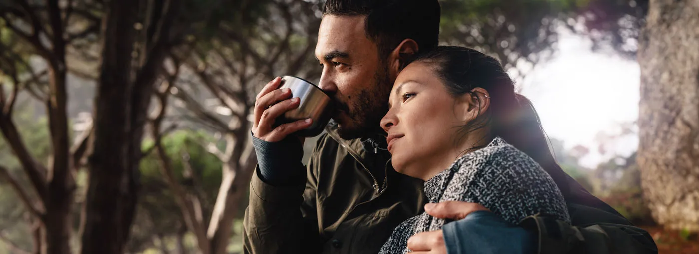 Image of a couple having coffee in the woods