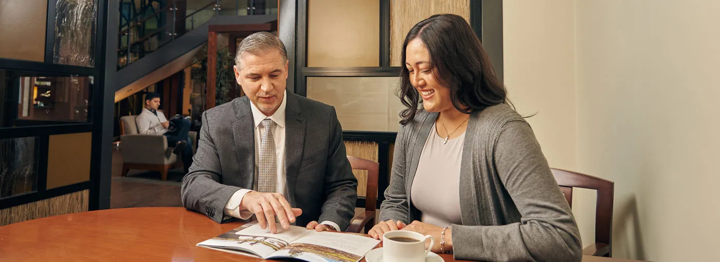 Advisor speaking with clients in a BlueShore branch.