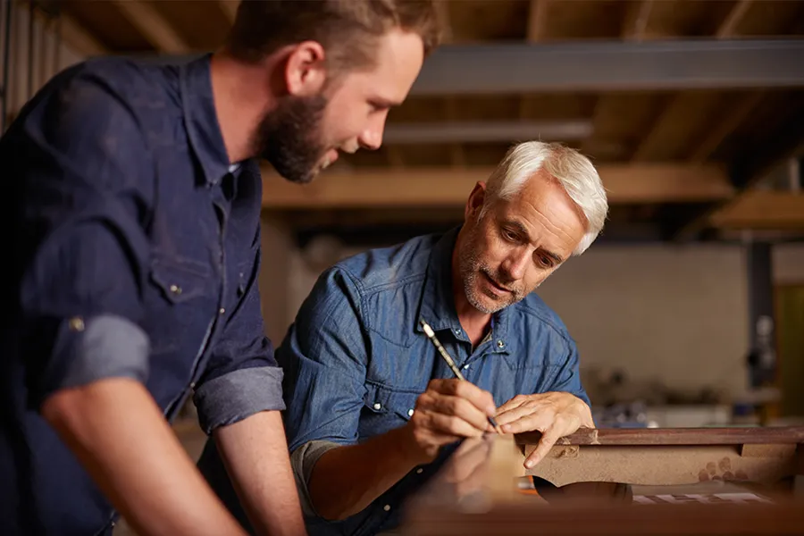 Two men working on a carpentry project together.