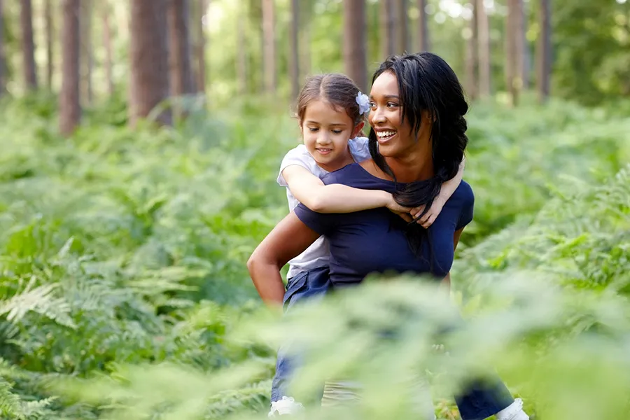 A woman and child exploring the woods in British Columbia.