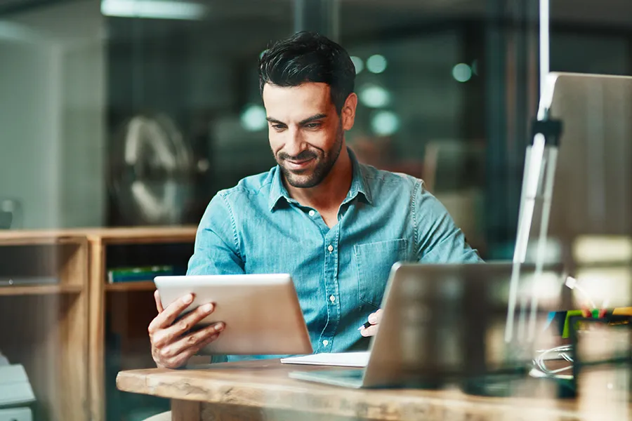 A man looking at his tablet.
