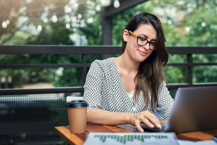 A woman typing on her laptop.