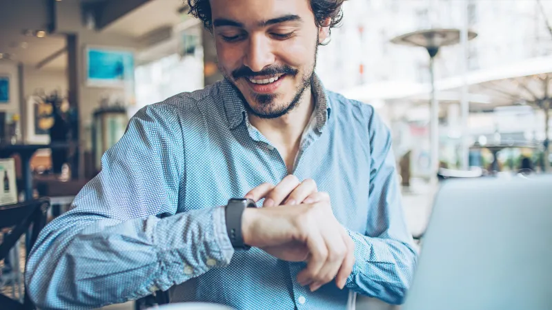 Man checking alert on watch