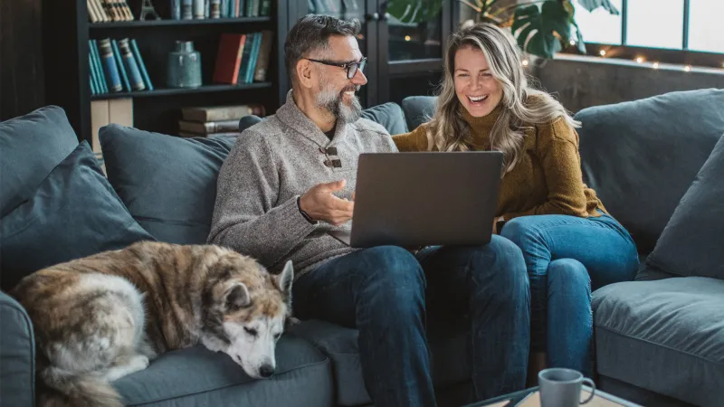 Couple on sofa looking at computer