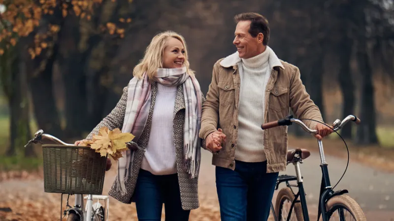 Couple out for a bike ride in fall