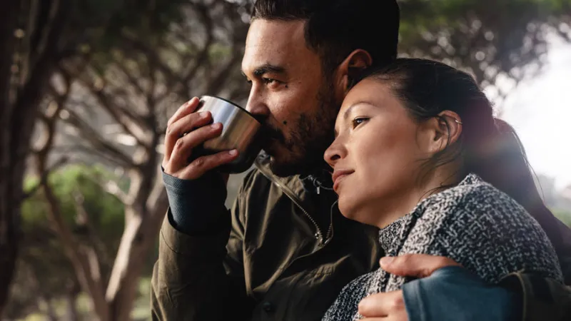 Image of a couple having coffee in the woods